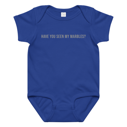 "Have you seen my marbles?" printed on a royal baby jersey bodysuit laying on a flat surface amongst other clothes