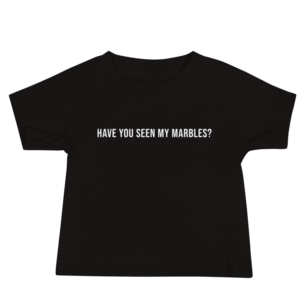 "Have you seen my marbles?" printed on a black baby jersey short sleeve tee laying on a flat surface