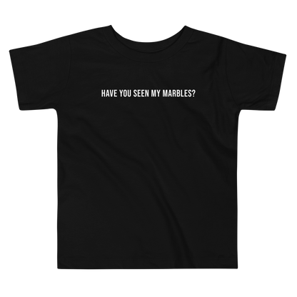 "Have you seen my marbles?" printed on a black toddler short sleeve tee laying on a flat surface