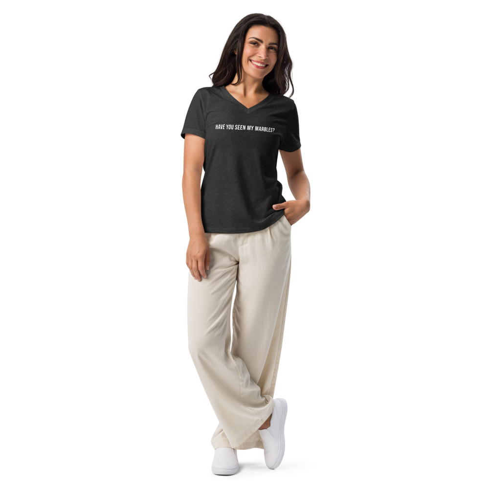"Have you seen my marbles?" printed on a dark grey heather women's relaxed v-neck t-shirt worn by a female