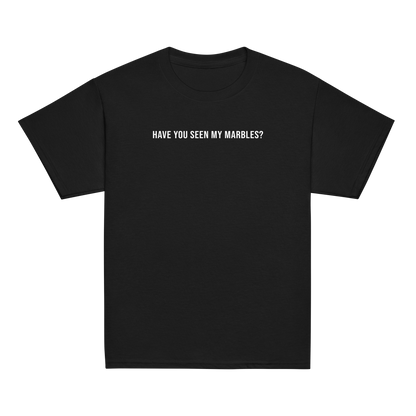 "Have you seen my marbles?" printed on a black youth classic tee laying on a flat surface
