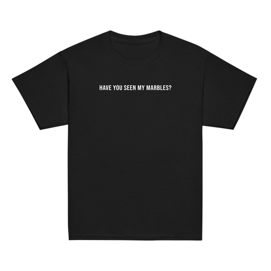 "Have you seen my marbles?" printed on a black youth classic tee laying on a flat surface