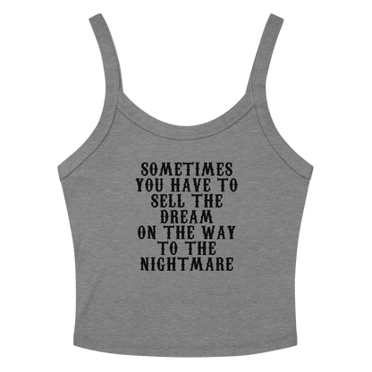 "Sometimes you have to sell the dream on the way to the nightmare" printed on a athletic heather women's micro-rib tanktop laying on a flat surface amongst sunglasses and shorts
