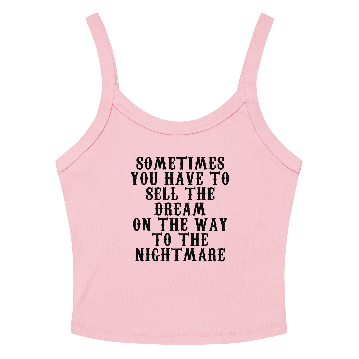 "Sometimes you have to sell the dream on the way to the nightmare" printed on a solid pink blend women's micro-rib tanktop laying on a flat surface amongst sunglasses and shorts