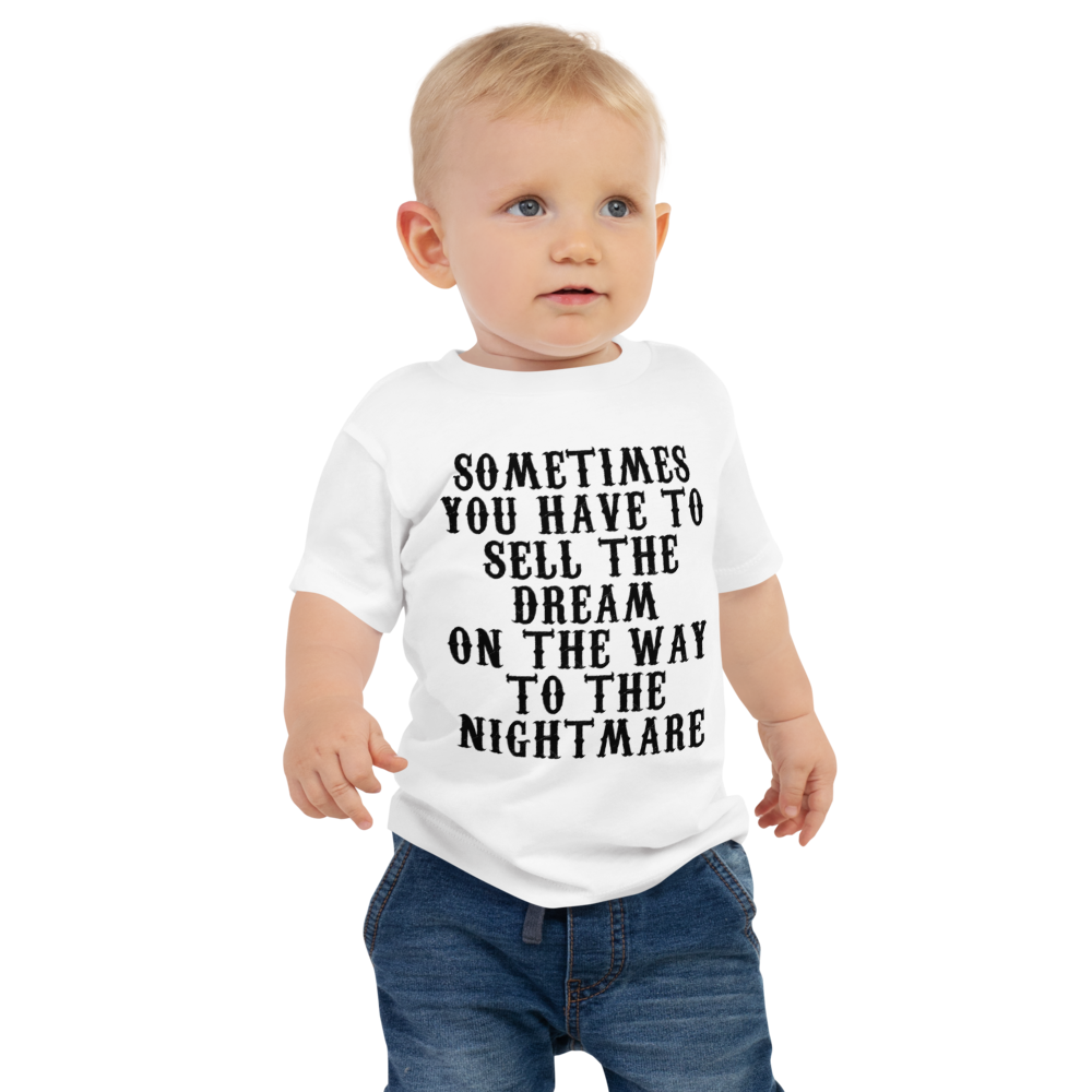 "Sometimes you have to sell the dream on the way to the nightmare" printed on a white baby jersey short sleeve tee worn by a male