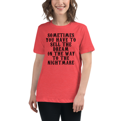 "Sometimes you have to sell the dream on the way to the nightmare" printed on a heather red women's relaxed t-shirt worn by a female
