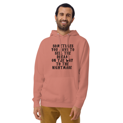 "Sometimes you have to sell the dream on the way to the nightmare" printed on a dusty rose warn by a male