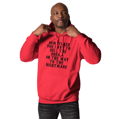 "Sometimes you have to sell the dream on the way to the nightmare" printed on a team red unisex hoodie worn by a male