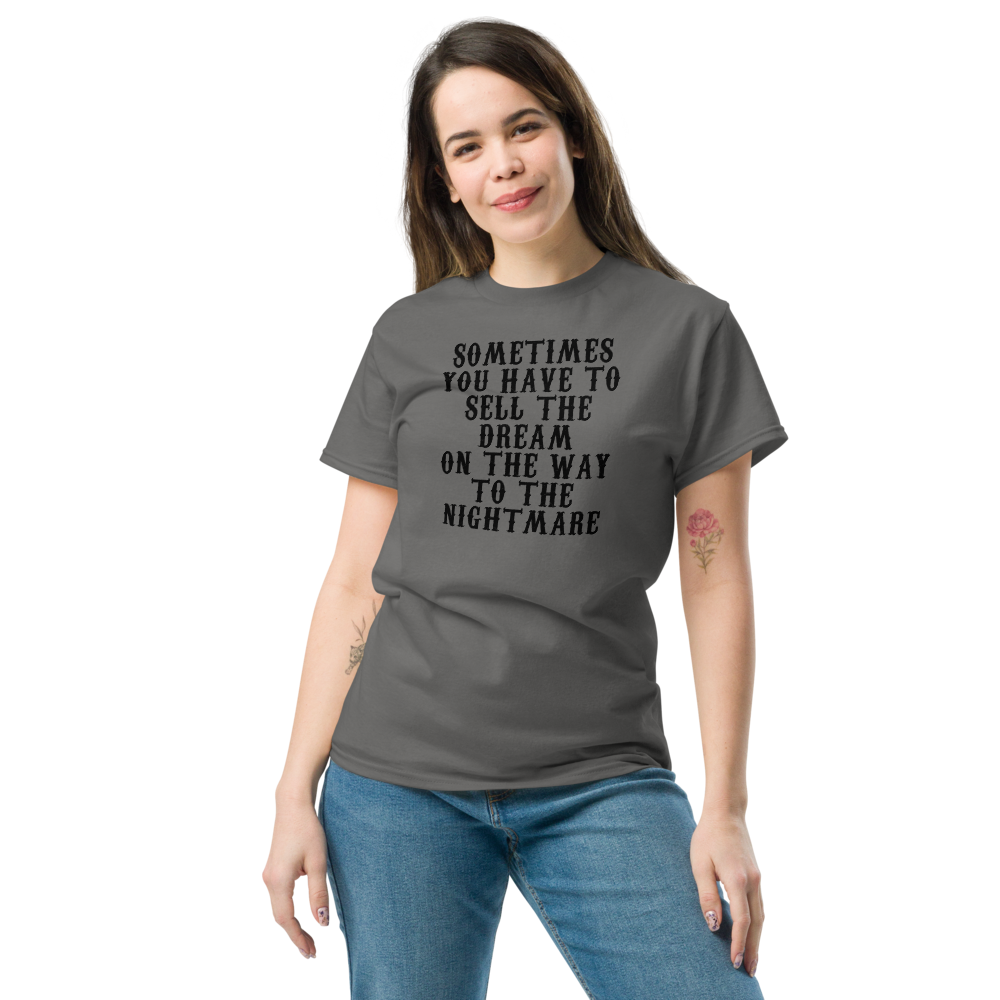 "Sometimes you have to sell the dream on the way to the nightmare" printed on a charcoal unisex classic tee worn by a female