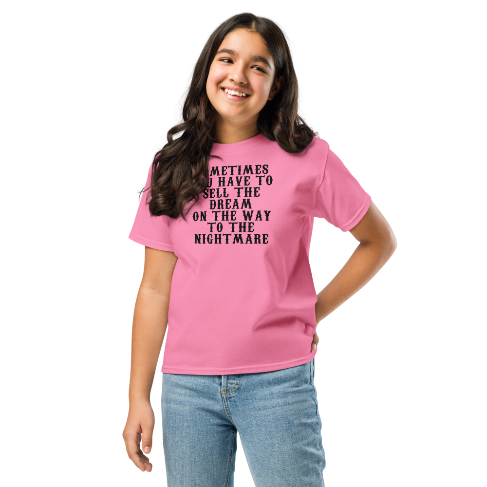 "Sometimes you have to sell the dream on the way to the nightmare" printed on a azalea youth classic tee worn by a female
