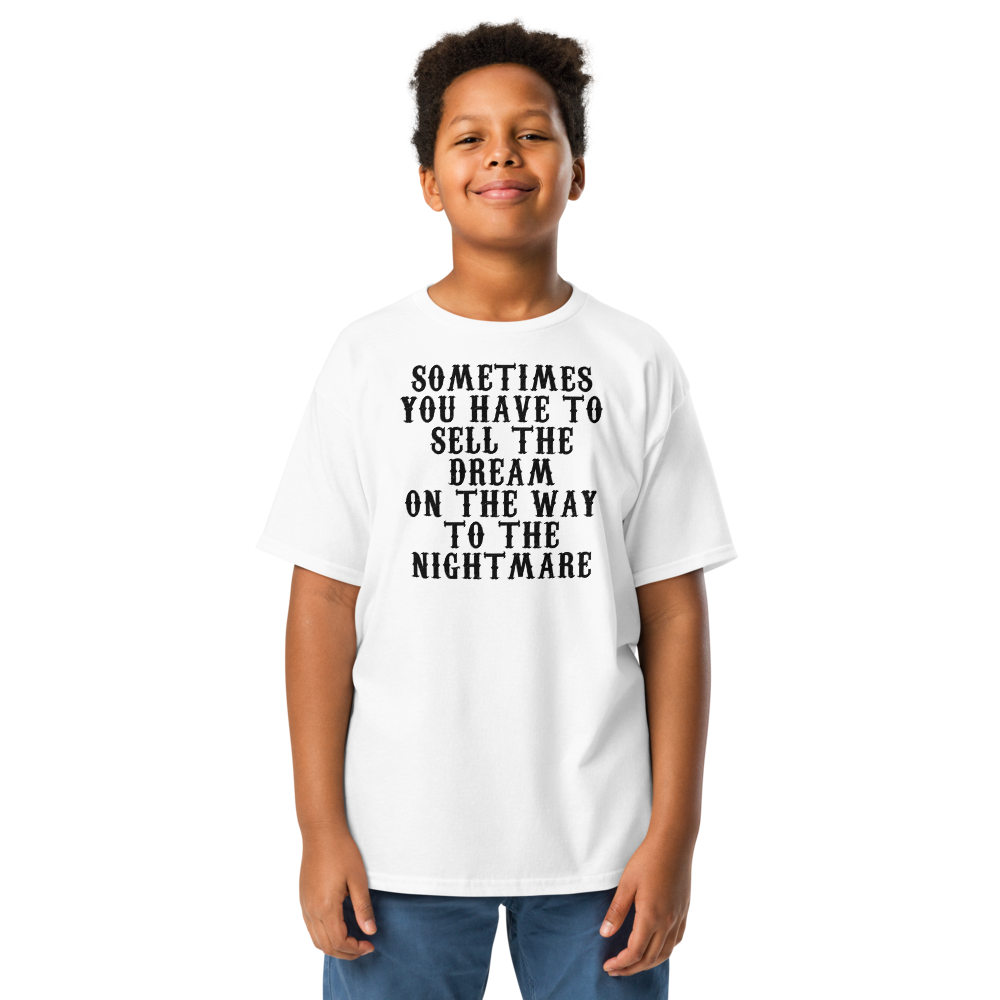 "Sometimes you have to sell the dream on the way to the nightmare" printed on a white youth classic tee worn by a male