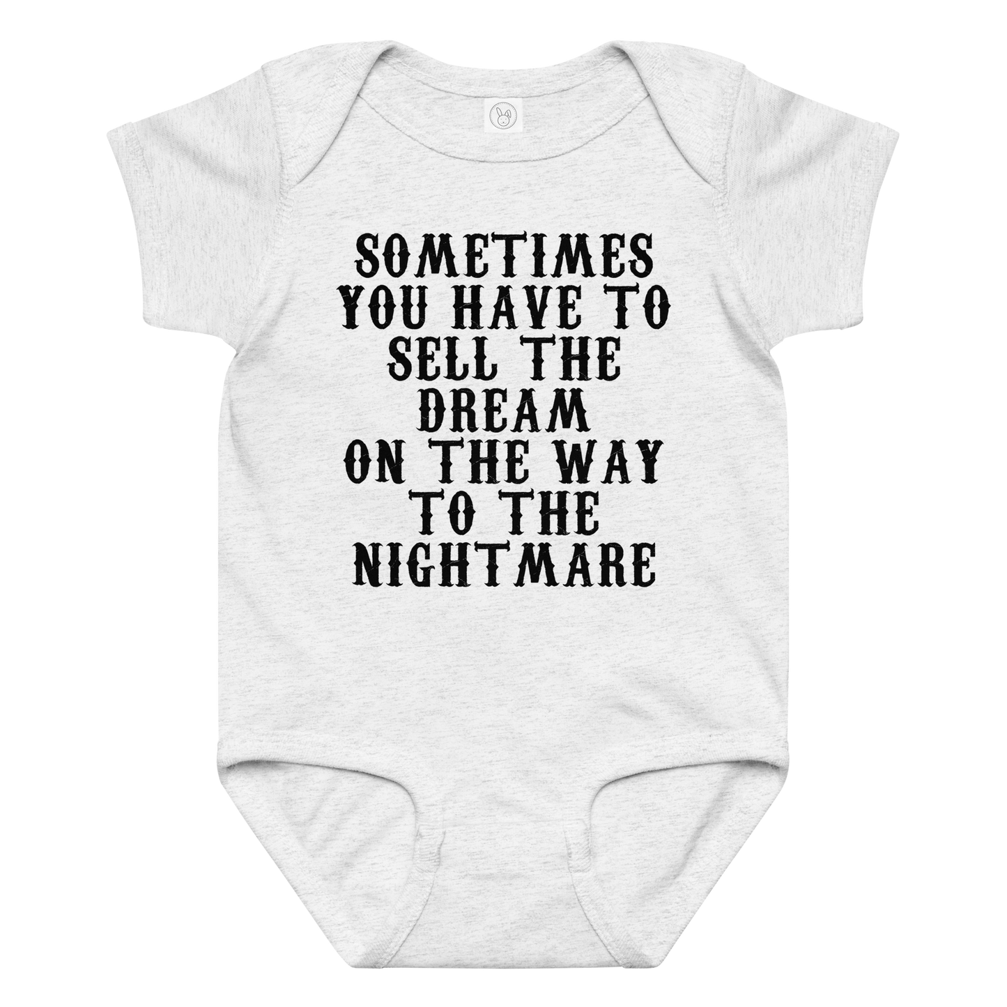 "Sometimes you have to sell the dream on the way to the nightmare" printed on a ash baby jersey bodysuit laying on a flat surface amongst other clothes
