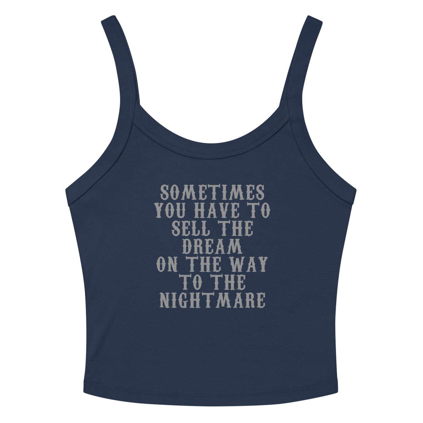 "Sometimes you have to sell the dream on the way to the nightmare" printed on a solid navy blend women's micro-rib tanktop laying on a flat surface amongst sunglasses and shorts