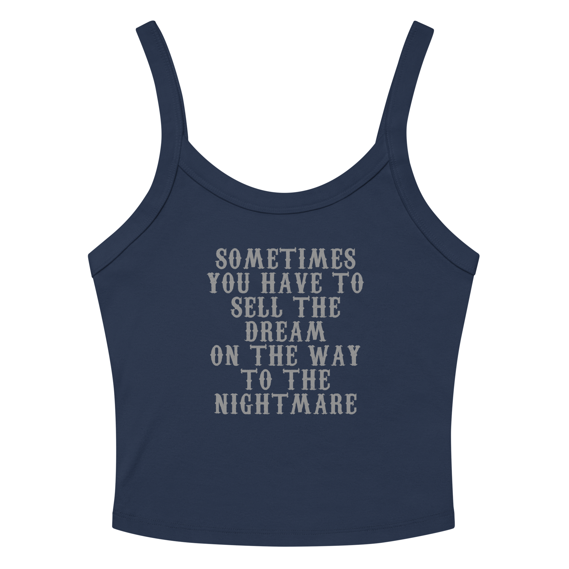 "Sometimes you have to sell the dream on the way to the nightmare" printed on a solid navy blend women's micro-rib tanktop laying on a flat surface amongst sunglasses and shorts