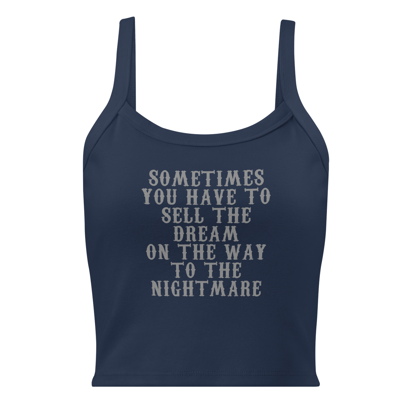"Sometimes you have to sell the dream on the way to the nightmare" printed on a solid navy blend women's micro-rib tanktop laying on a flat surface