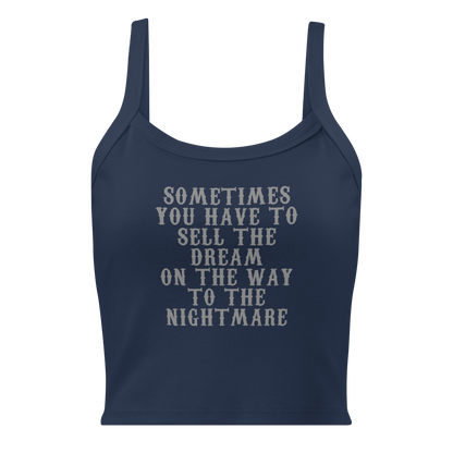 "Sometimes you have to sell the dream on the way to the nightmare" printed on a solid navy blend women's micro-rib tanktop laying on a flat surface