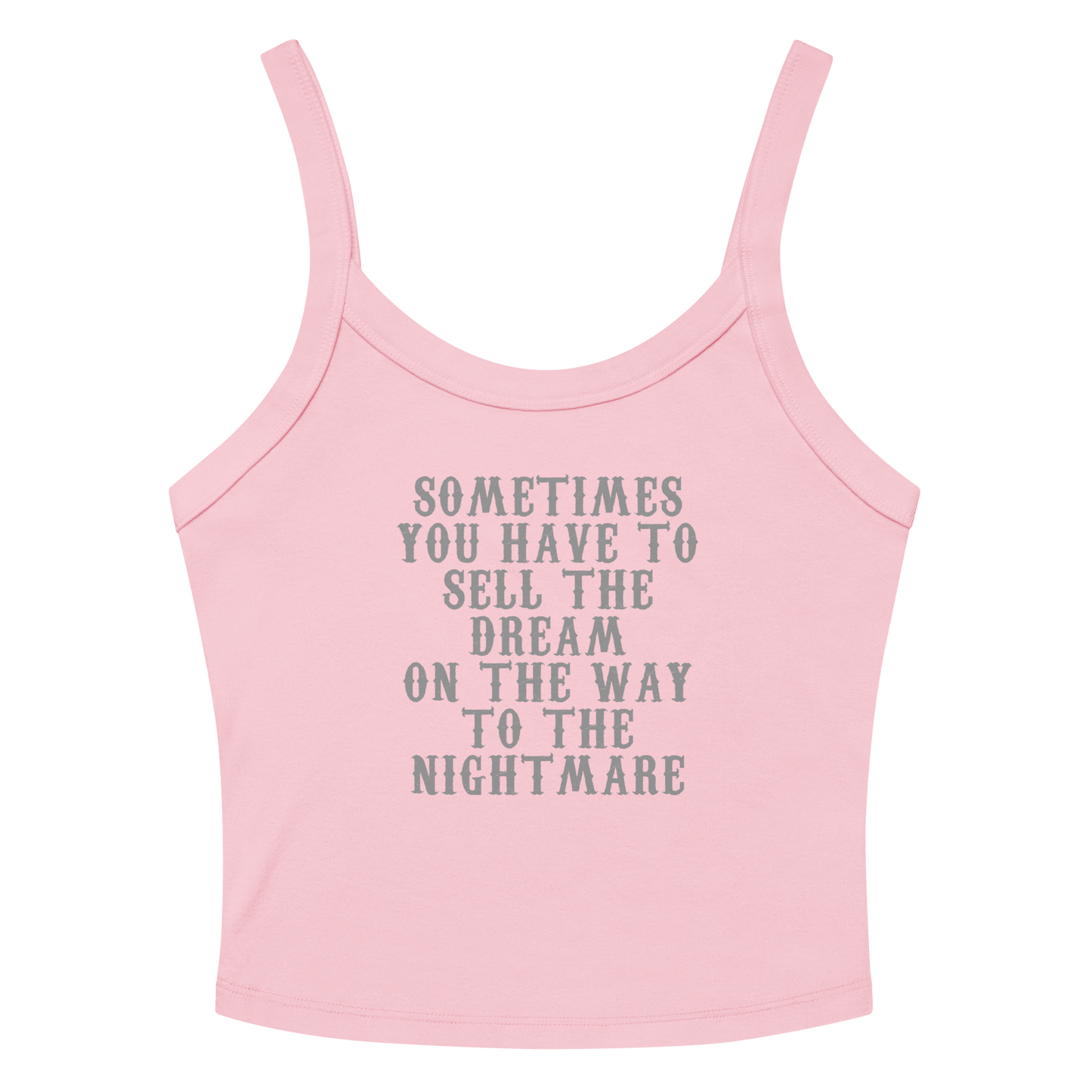 "Sometimes you have to sell the dream on the way to the nightmare" printed on a solid pink blend women's micro-rib tanktop laying on a flat surface amongst sunglasses and shorts