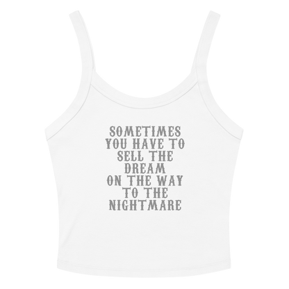 "Sometimes you have to sell the dream on the way to the nightmare" printed on a solid white blend women's micro-rib tanktop laying on a flat surface amongst sunglasses and shorts