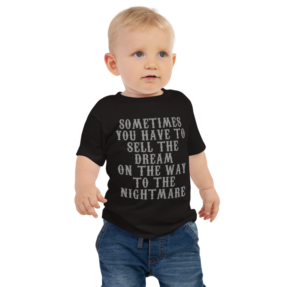 "Sometimes you have to sell the dream on the way to the nightmare" printed on a black baby jersey short sleeve tee worn by a male