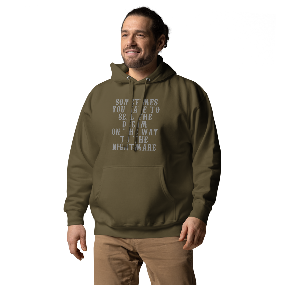"Sometimes you have to sell the dream on the way to the nightmare" printed on a military green unisex hoodie worn by a male