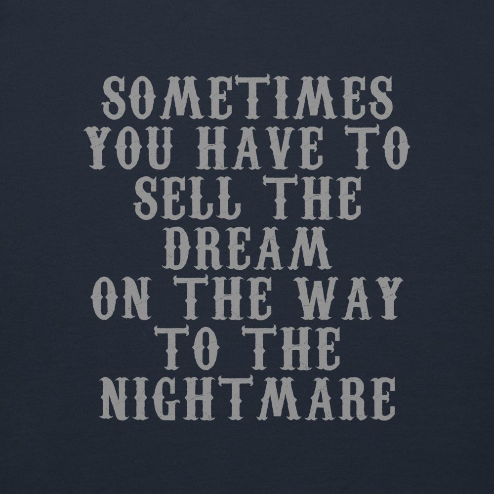 "Sometimes you have to sell the dream on the way to the nightmare" printed on a navy blazer background