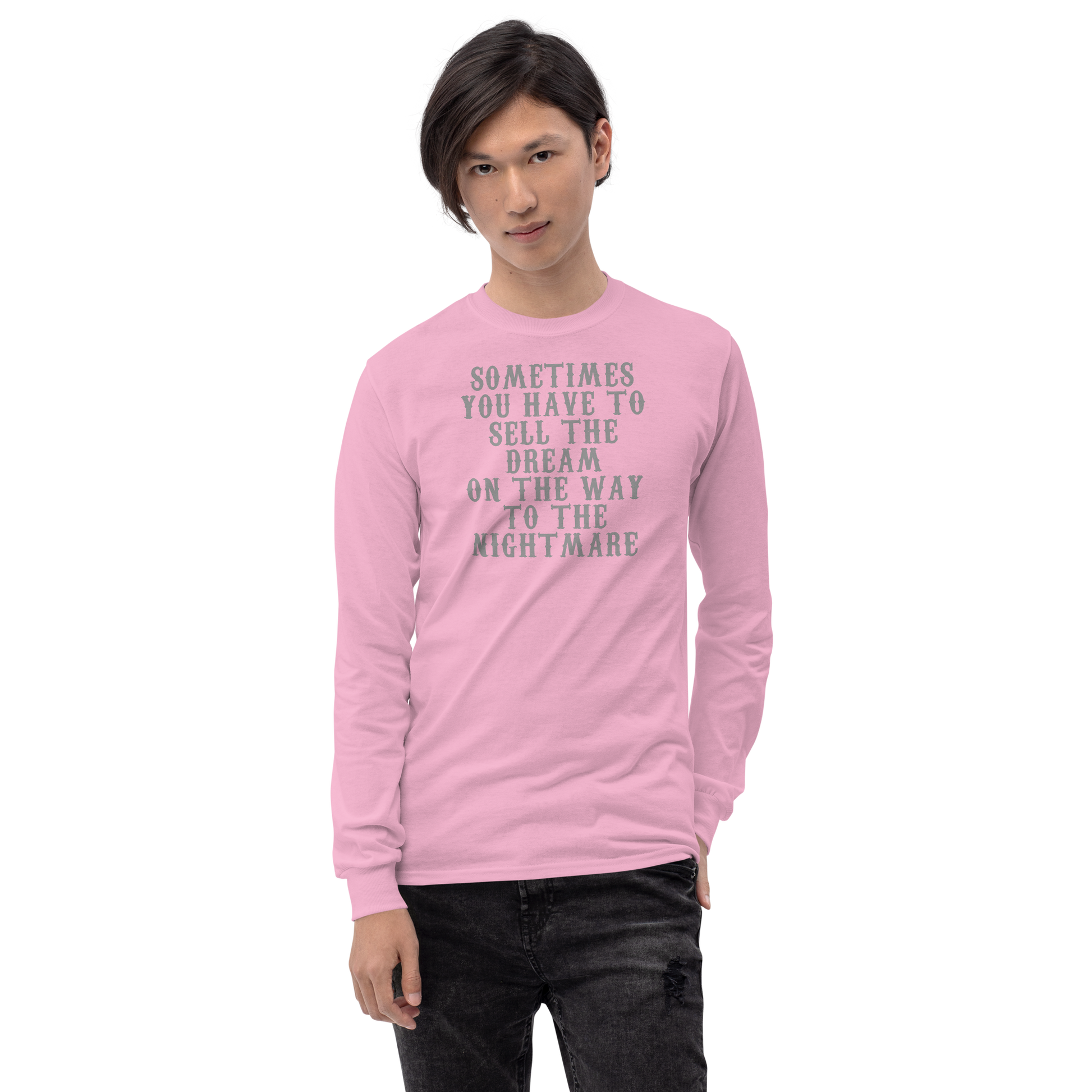 "Sometimes you have to sell the dream on the way to the nightmare" printed on a light pink men's long sleeve shirt worn by a male