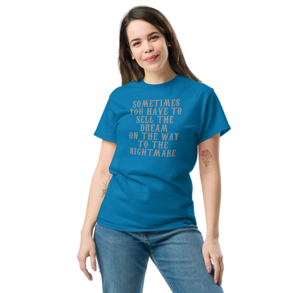 "Sometimes you have to sell the dream on the way to the nightmare" printed on a sapphire unisex classic tee worn by a female