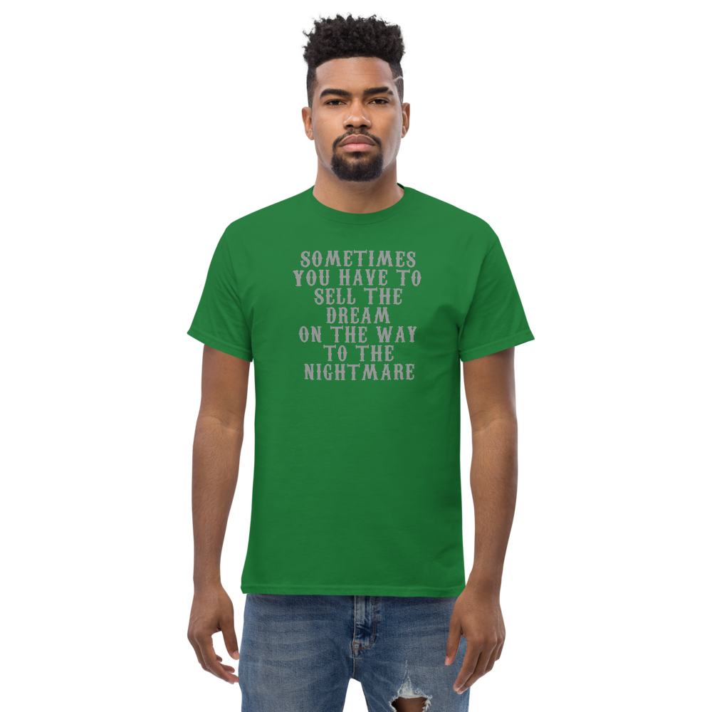 "Sometimes you have to sell the dream on the way to the nightmare" printed on a turf green unisex classic tee worn by a male