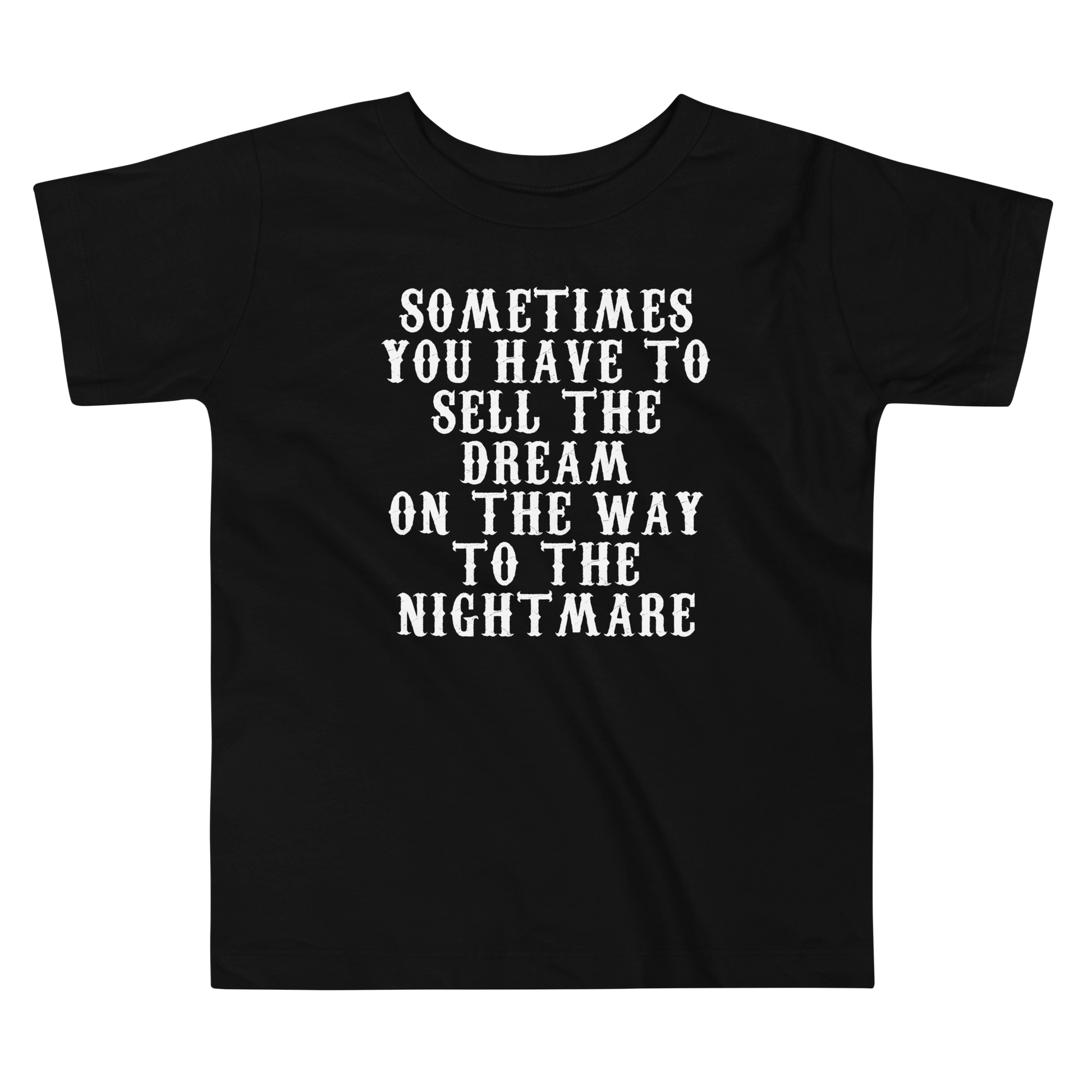 "Sometimes you have to sell the dream on the way to the nightmare" printed on a black toddler short sleeve tee laying on a flat surface