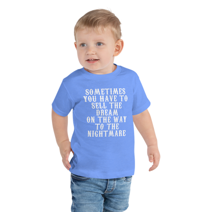 "Sometimes you have to sell the dream on the way to the nightmare" printed on a heather columbia blue toddler short sleeve tee worn by a male
