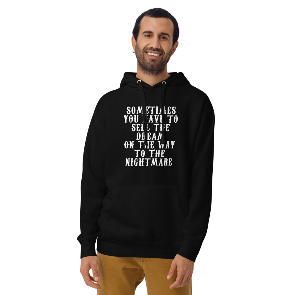 "Sometimes you have to sell the dream on the way to the nightmare" printed on a black warn by a male