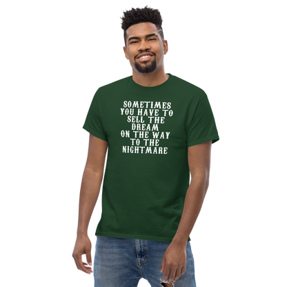 "Sometimes you have to sell the dream on the way to the nightmare" printed on a forest green unisex classic tee worn by a male