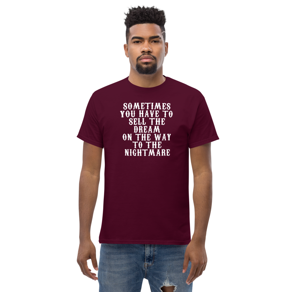 "Sometimes you have to sell the dream on the way to the nightmare" printed on a maroon unisex classic tee worn by a male