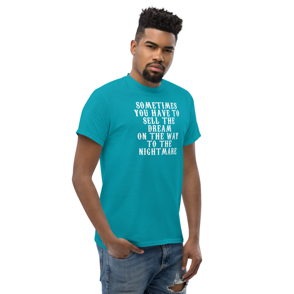 "Sometimes you have to sell the dream on the way to the nightmare" printed on a tropical blue unisex classic tee worn by a male