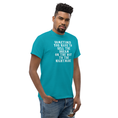 "Sometimes you have to sell the dream on the way to the nightmare" printed on a tropical blue unisex classic tee worn by a male