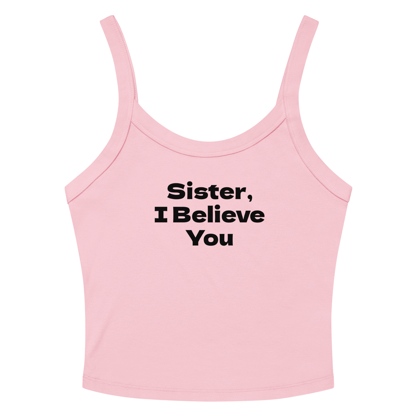 "Sister, I Believe You!" printed on a solid pink blend women's micro-rib tanktop laying on a flat surface amongst sunglasses and shorts