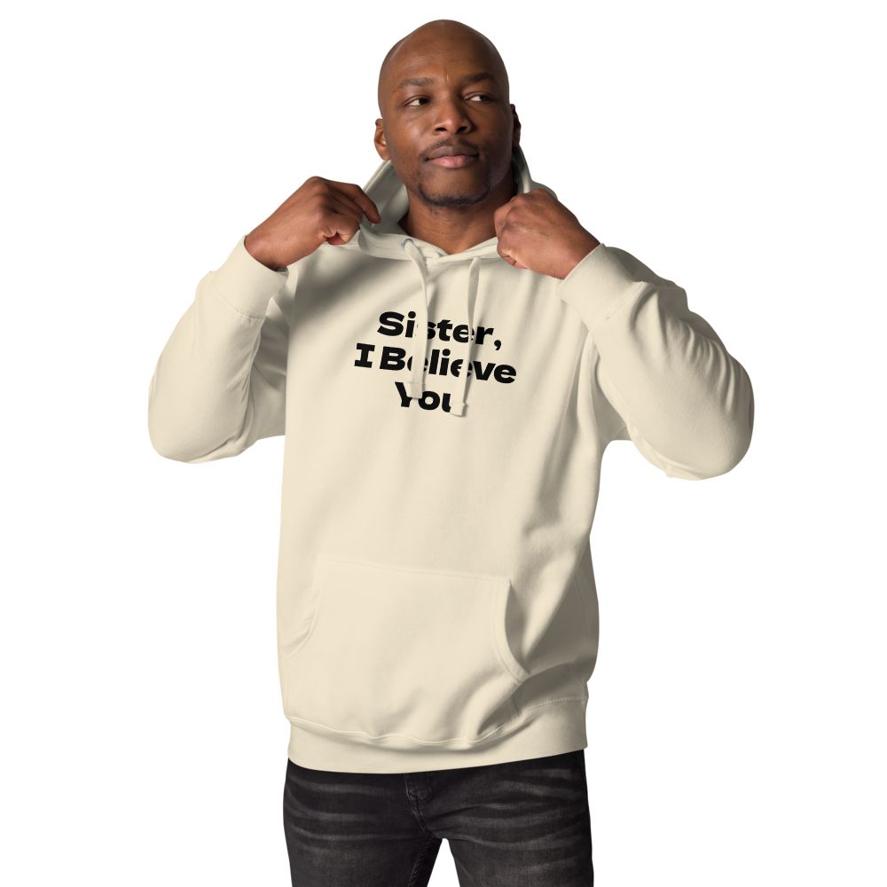 "Sister, I Believe You!" printed on a bone unisex hoodie worn by a male