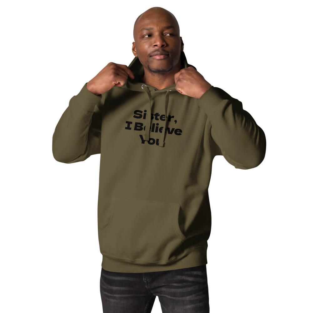 "Sister, I Believe You!" printed on a military green unisex hoodie worn by a male