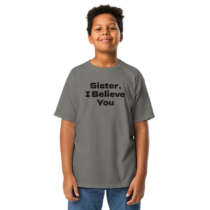 "Sister, I Believe You!" printed on a charcoal youth classic tee worn by a male