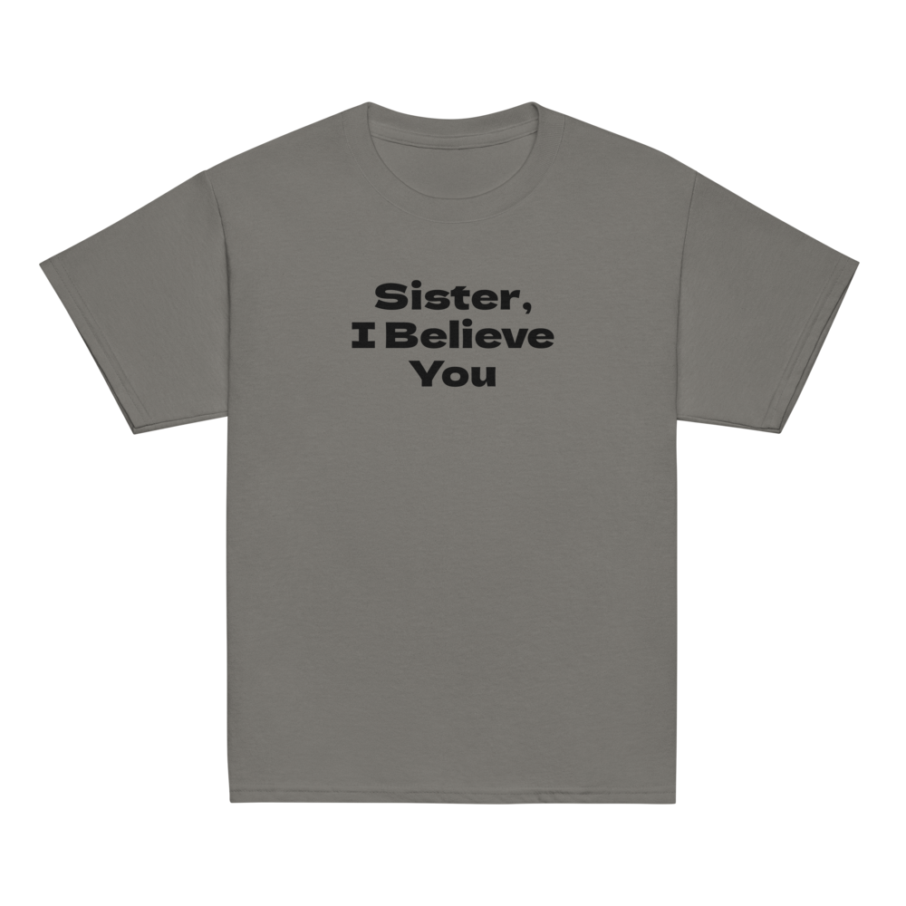 "Sister, I Believe You!" printed on a charcoal youth classic tee laying on a flat surface