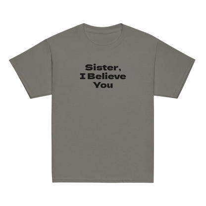 "Sister, I Believe You!" printed on a charcoal youth classic tee laying on a flat surface