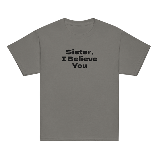 "Sister, I Believe You!" printed on a charcoal youth classic tee laying on a flat surface