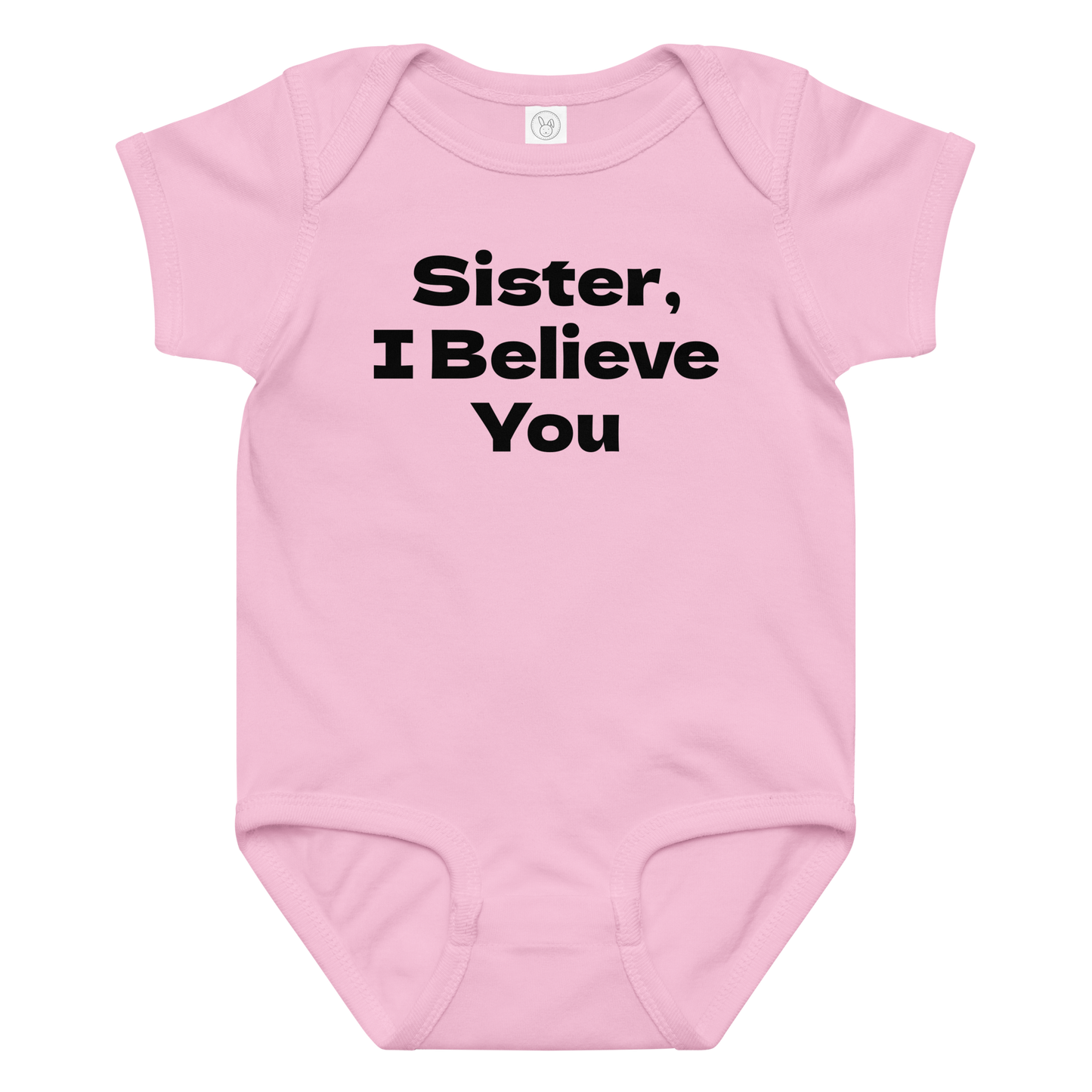 "Sister, I Believe You!" printed on a pink baby jersey bodysuit laying on a flat surface amongst other clothes