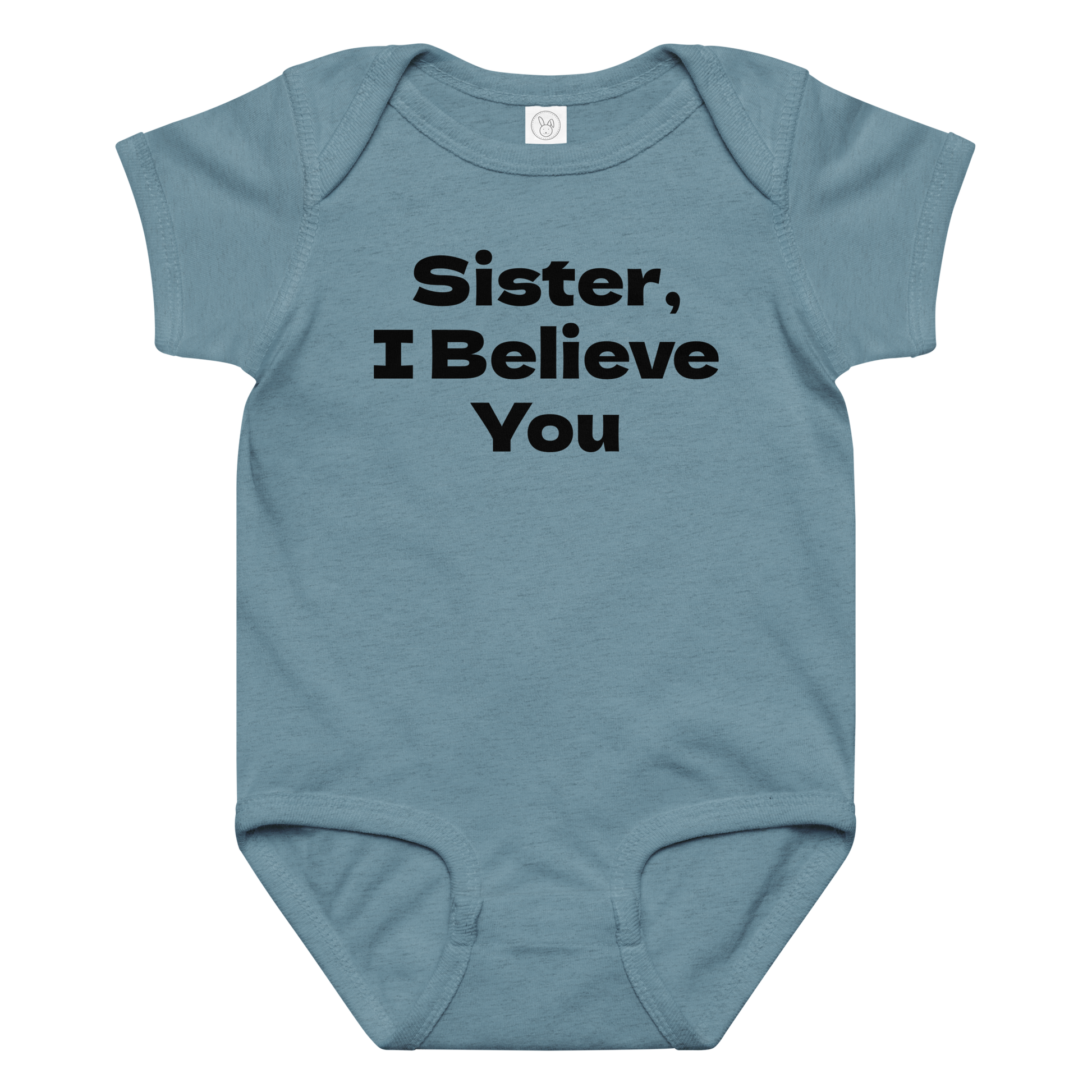 "Sister, I Believe You!" printed on a vintage indigo baby jersey bodysuit laying on a flat surface amongst other clothes