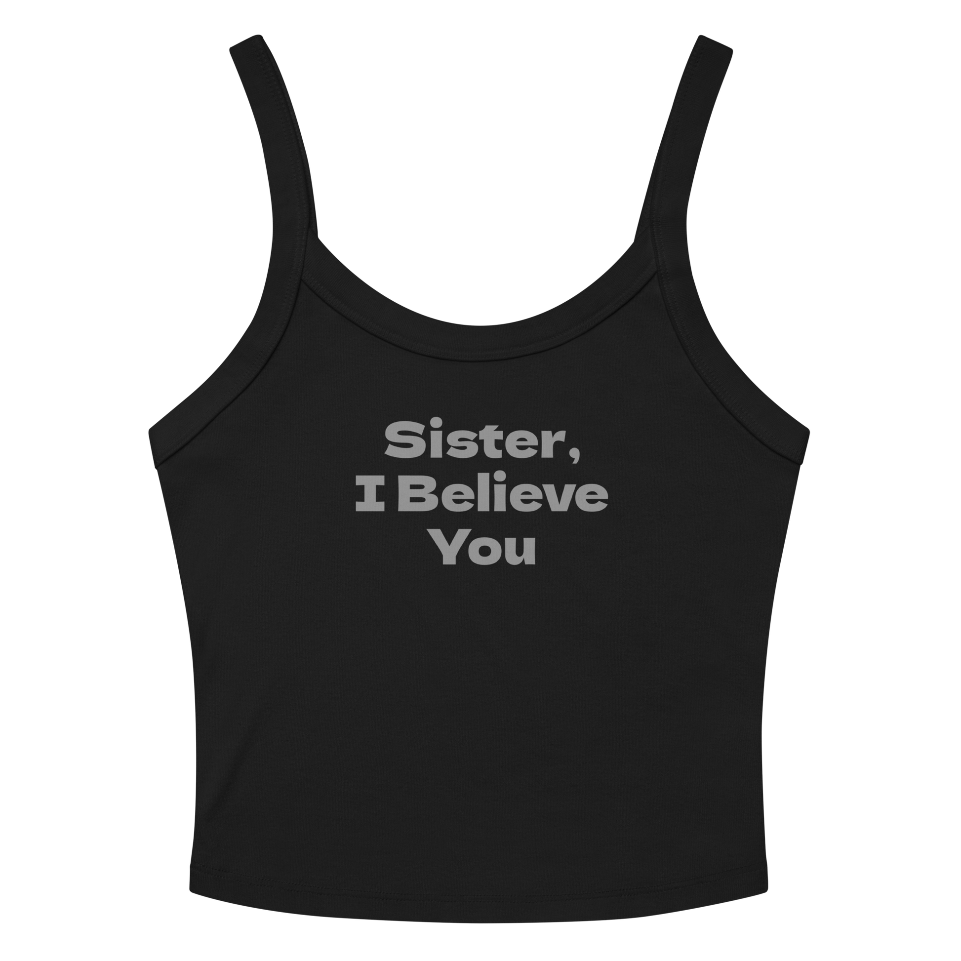 "Sister, I Believe You!" printed on a solid black blend women's micro-rib tanktop laying on a flat surface amongst sunglasses and shorts