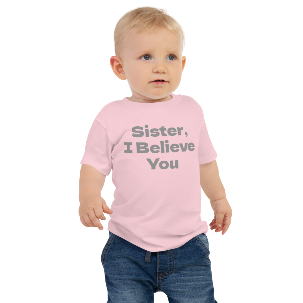 "Sister, I Believe You!" printed on a pink baby jersey short sleeve tee worn by a male