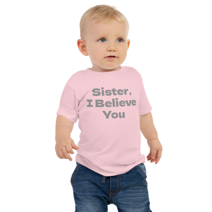 "Sister, I Believe You!" printed on a pink baby jersey short sleeve tee worn by a male
