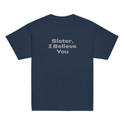 "Sister, I Believe You!" printed on a navy youth classic tee laying on a flat surface