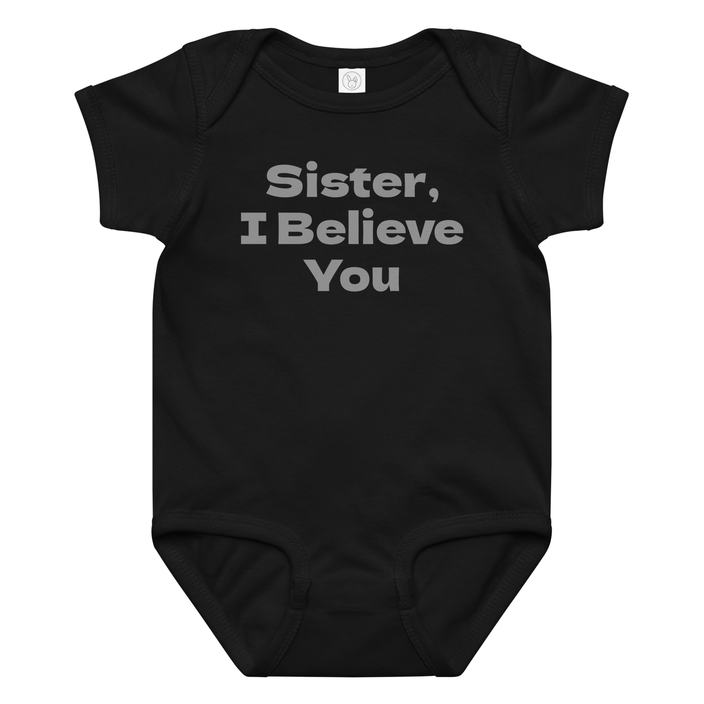 "Sister, I Believe You!" printed on a black baby jersey bodysuit laying on a flat surface amongst other clothes