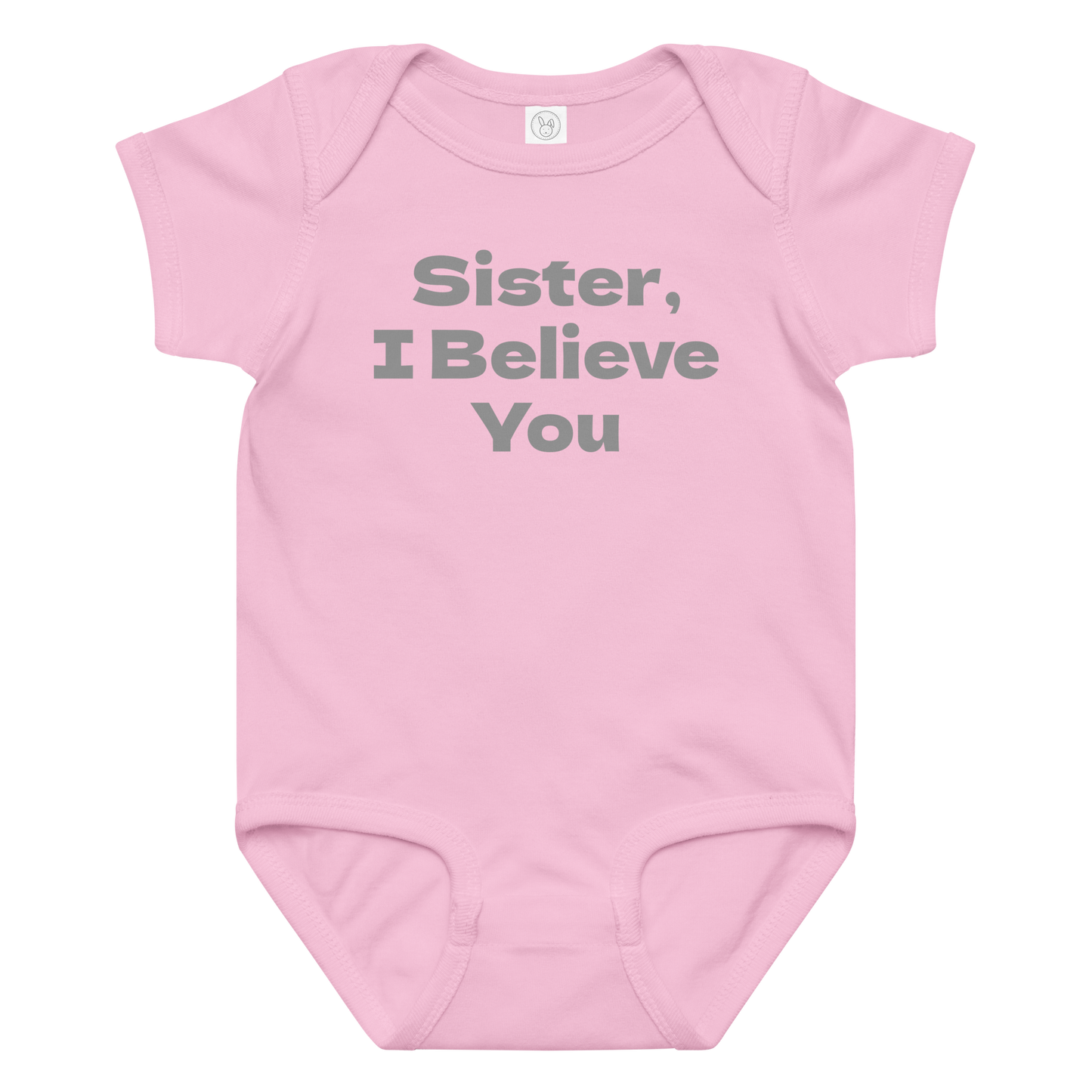"Sister, I Believe You!" printed on a pink baby jersey bodysuit laying on a flat surface amongst other clothes